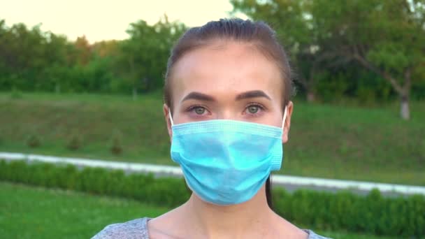 Portrait of young woman in medical mask. - Video