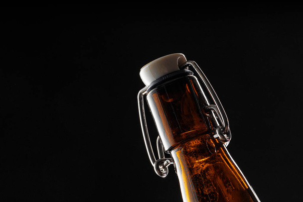 Beer bottle on dark background, copy space - Fotoğraf, Görsel