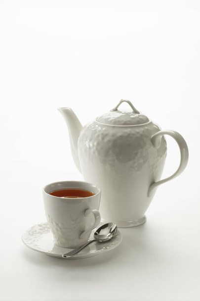 Close up view of china teapot and cup on white background - Fotoğraf, Görsel