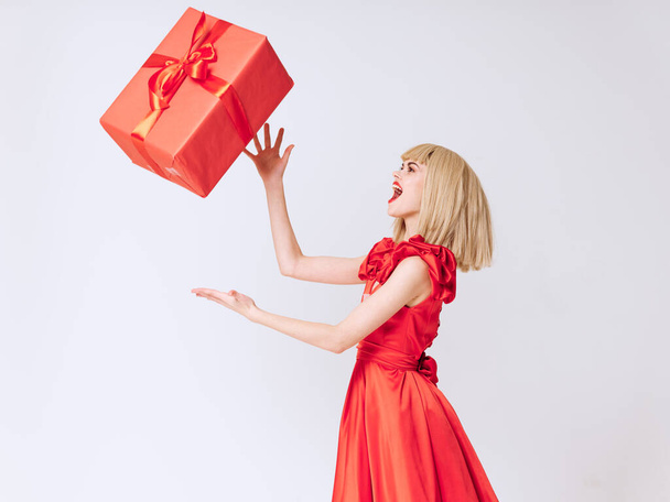 Cheerful beautiful charm woman red dress holiday gift luxury  - Фото, изображение