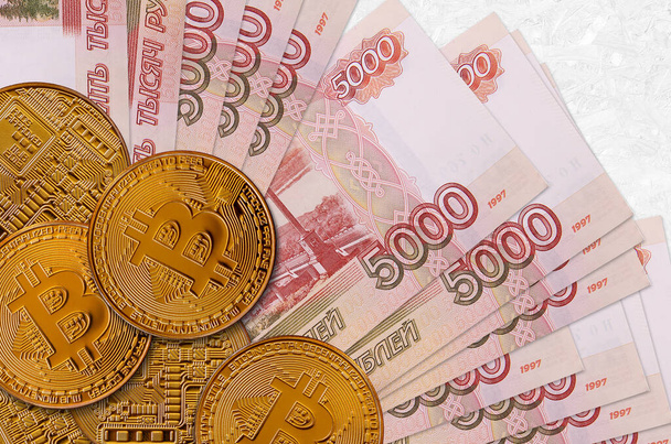 5000 russian rubles bills and golden bitcoins. Cryptocurrency investment concept. Crypto mining or trading transactions - Photo, Image