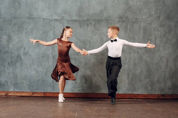 Young dancers boy and girl dancing in ballroom dance Samba - Photo, Image