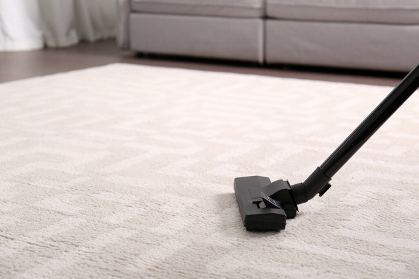 Hoovering floor with modern vacuum cleaner, closeup. Space for text - Fotó, kép