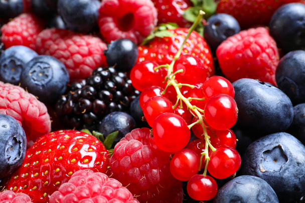 Mix of different ripe tasty berries as background, closeup view - Foto, Bild
