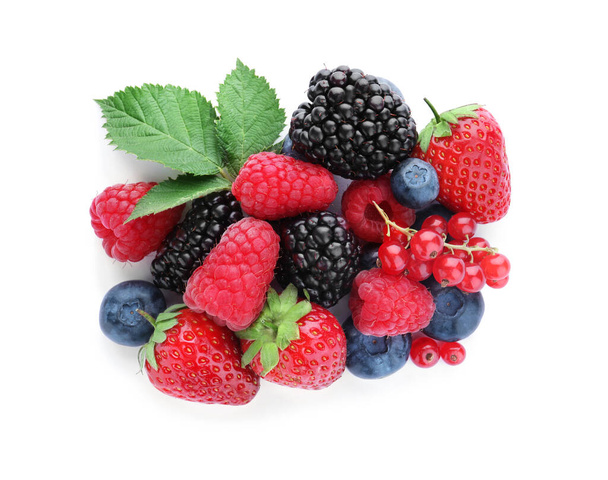 Pile of different ripe tasty berries and green leaves isolated on white, top view - 写真・画像