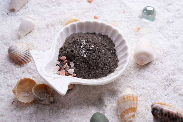  black clay around  marine salt and shells background. Healthy concept.  - Foto, immagini