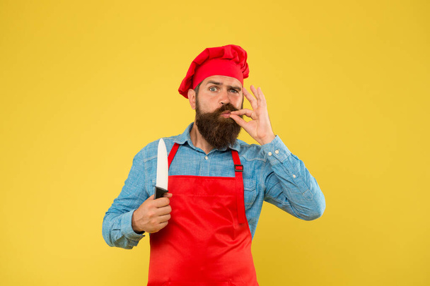 Deserve well. restaurant cuisine and culinary. catering company ad. taste approval gesture. time to eat. bearded chef hold knife. brutal male cook in hat and apron. professional man cooking - Fotografie, Obrázek