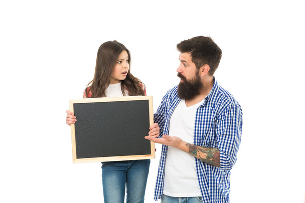 Advertising or promotion. Father and daughter hold chalkboard copy space. Family news. Sale and discount. We love it. Girl with dad on white background. International childrens day. Happy childhood - Foto, imagen