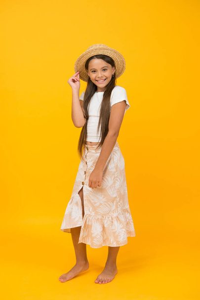 smiling cutie in straw hat. happy childhood concept. small girl has long healthy hair. kid beauty and fashion. she love summer holiday. its vacation time. feel happy and carefree - 写真・画像