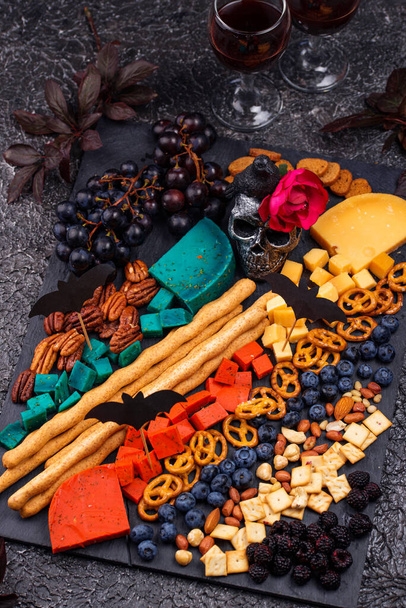 Halloween appetizers. Cheese plate with snacks - Photo, Image
