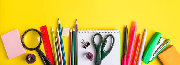 Back to school concept. Flat lay of office supplies on a yellow background. Place for text. Banner format - Photo, Image