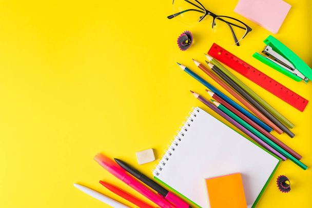 Flat lay of stationery on a yellow background. Back to school concept. Place for text. - Photo, Image