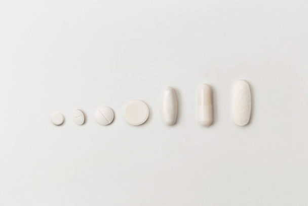 Medical pills various shapes on a white background - Fotoğraf, Görsel