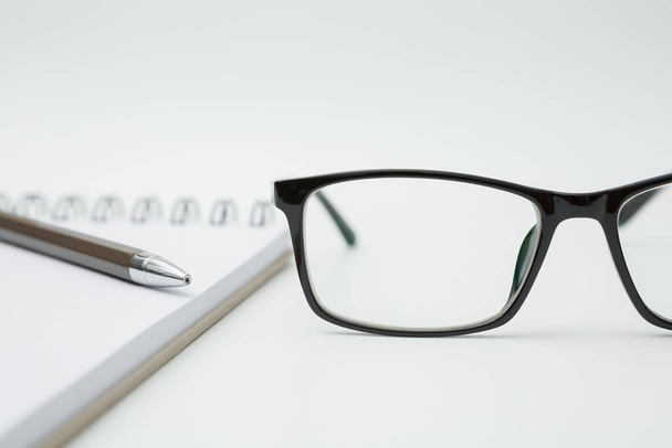 Selective focus of Notebooks, pens, glasses on white background and copy space - Photo, Image