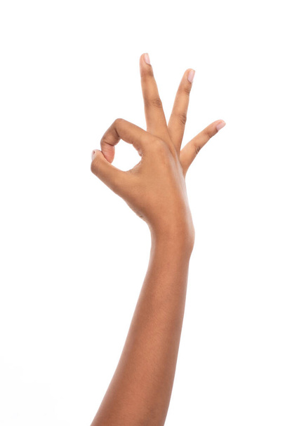 Hand of woman show gesture fingers symbol of OK, studio light shooting isolated on white background - Photo, Image