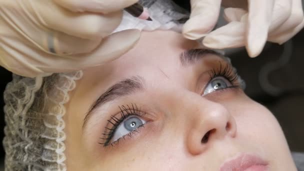The microblading master corrects the new shape of the eyebrows with a special pencil. Eyebrow Tattoo, Permanent Makeup - Footage, Video