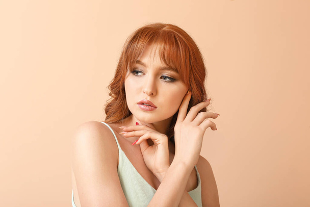 Beautiful young redhead woman on color background - Photo, Image