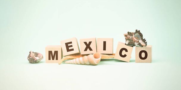 word Mexico made wooden cubes seashells and starfish on mint - Φωτογραφία, εικόνα