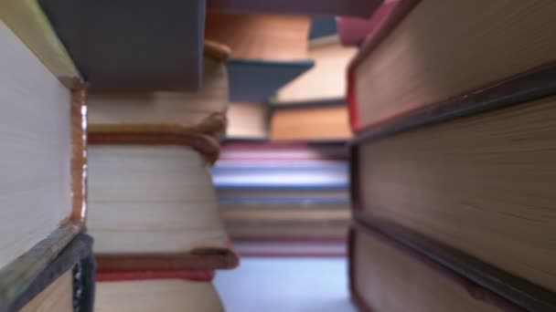 super close up details. view between stacks of many books - Кадры, видео