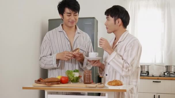 Asian gay couple homosexual cooking together in the kitchen prepare fresh vegetable make organic salad healthy food. Asian people happy time smile, laugh in kitchen. LGBTQ relation lifestyle concept - Footage, Video