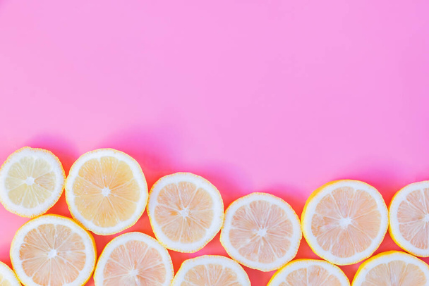 Collection of fresh yellow lemons slice isolated on pink background.  - Photo, Image