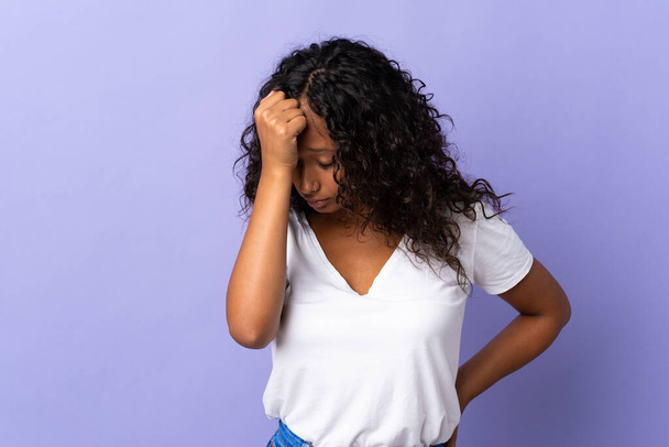 Teenager cuban girl isolated on purple background with headache - Foto, afbeelding
