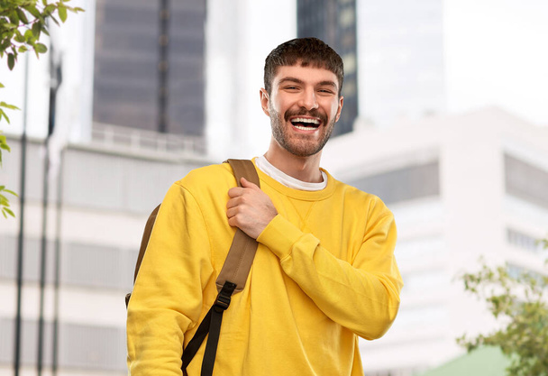 happy smiling young man with backpack in city - Foto, immagini