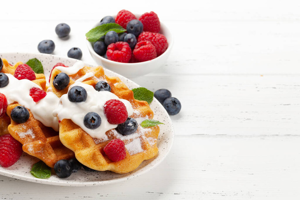 Delicious belgian waffles with ice cream and summer berries. With copy space - Foto, imagen