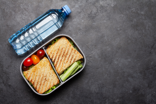 Boîte à lunch saine avec sandwich et légumes sur table en pierre. Vue supérieure avec espace de copie. Pose plate - Photo, image
