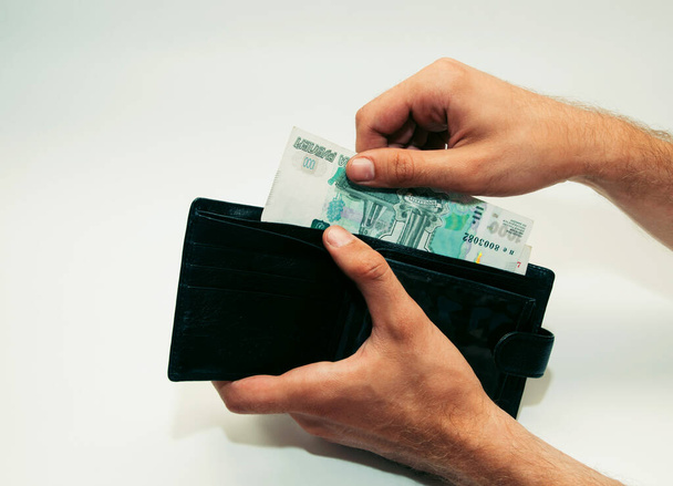 male hand takes paper money out of wallet - Фото, зображення