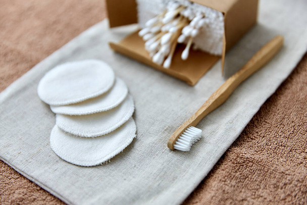 wooden toothbrush, cotton pads and swabs in box - Photo, Image