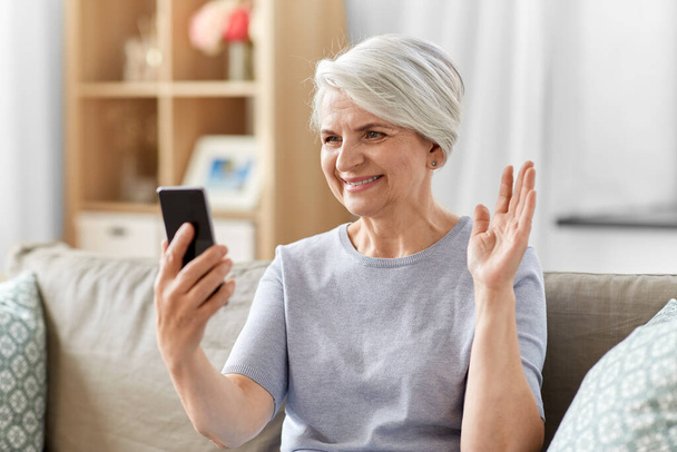 senior woman having video call on smartphone - Photo, image