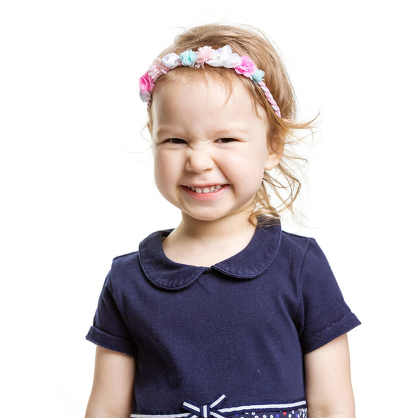 Cute little girl making faces over white background - Foto, Bild