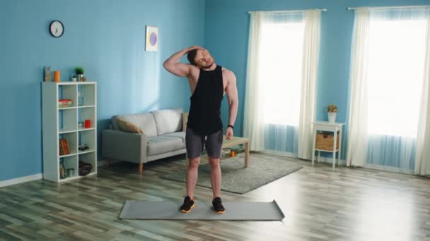 Athletic Man is Warming Up at Home - Materiał filmowy, wideo