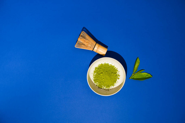  Matcha tea. A traditional oriental drink for health and energy. Powdered green tea and whisk. Photos are sharp in sharpness and hard light. Copy space. Above - Photo, Image