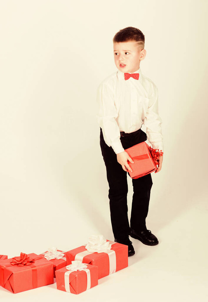 Shopping. Boxing day. New year. little boy with valentines day gift. happy child with present box. Christmas. tuxedo style. Happy childhood. Birthday party. Thanks for your purchase - Foto, Imagem