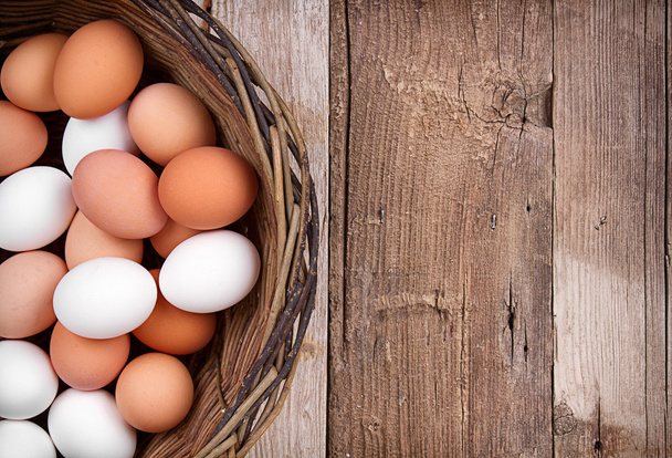 Brown eggs in a basket - Фото, изображение
