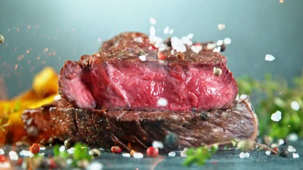 Close-up of falling tasty beef steak, slow motion. - Imágenes, Vídeo