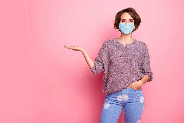 Portrait of her she nice attractive content healthy girl wearing safety gauze mask holding on palm copy space infection disease medicine therapy isolated over pink pastel color background - Fotoğraf, Görsel
