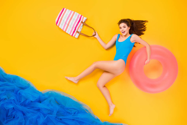 Top view above high angle flat lay flatlay lie concept full length body size view of attractive glad cheery girl spending time plage ocean isolated bright vivid shine vibrant yellow color background - Φωτογραφία, εικόνα