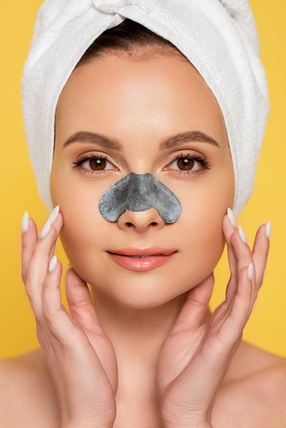 beautiful naked woman with towel on head and blackhead remover on  nose isolated on yellow - Photo, Image