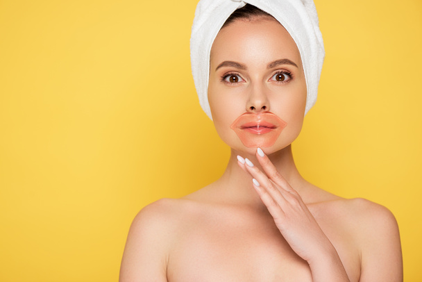 naked beautiful woman with towel on head, lip patch isolated on yellow - Photo, Image