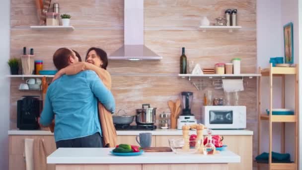 Tender couple dancing in kitchen - Filmati, video