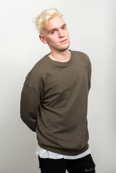 Студийный снимок молодого человека с светлыми волосами на белом фоне
 - Фото, изображение