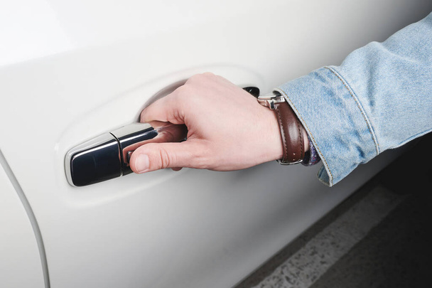 Hand hold handle of white car with touch lock close up view - Photo, Image
