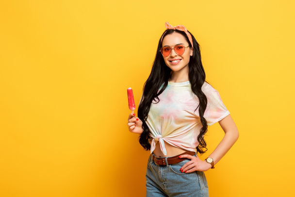 smiling stylish summer brunette girl with ice cream on yellow background - Фото, изображение