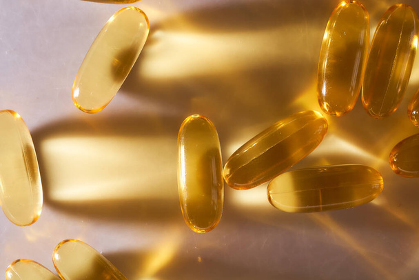 Golden Capsules Omega 3 Vitamins Lie On White Background. High quality photo - Photo, Image