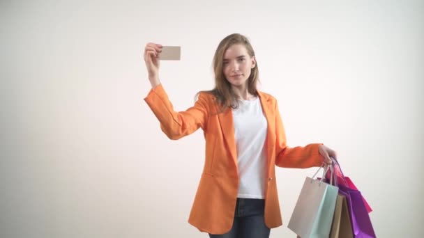 Happy contented girl made purchases at a big discount. Card in the hands. - Video, Çekim