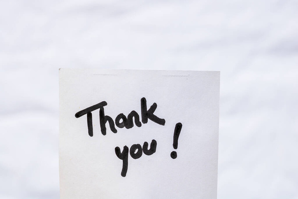 Thank you handwriting text close up isolated on white paper with copy space. Writing text on memo post reminder - Photo, Image