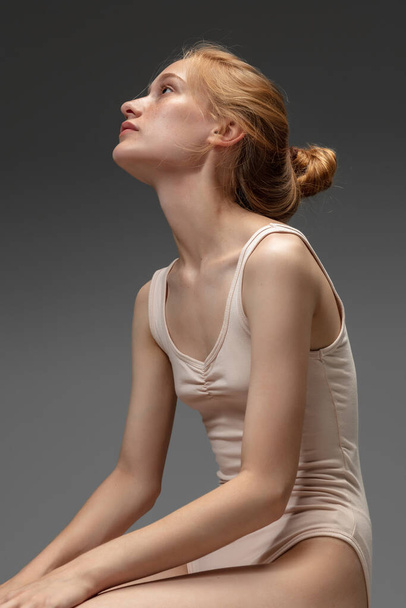 Portrait of beautiful redhead woman isolated on grey studio background. Concept of beauty, skin care, fashion and style - Valokuva, kuva